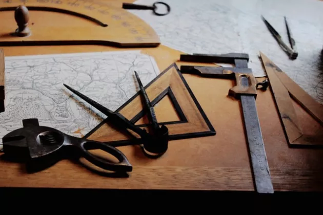 Measuring tools and maps on a wooden table