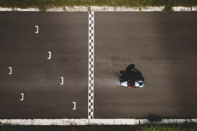 Aerial shot of a motorcyclist who has just crossed the finish line